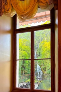 Grandhotel Giessbach with Window View over Giessbach waterfall in a Sunny Summer Day in Brienz
