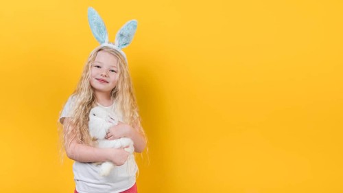 Blond girl bunny ears with rabbit