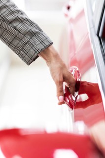 Businesswoman opening car door