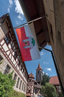 Waving Lauf town flag in the former Glockengiesser Spital