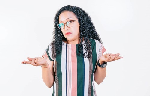 Afro girl with puzzled face frowning. Puzzled afro woman making hand gestures isolated. Puzzled people gesturing with hands