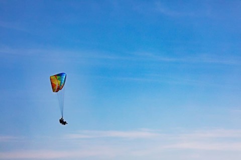 Tandem paragliding high in the sky