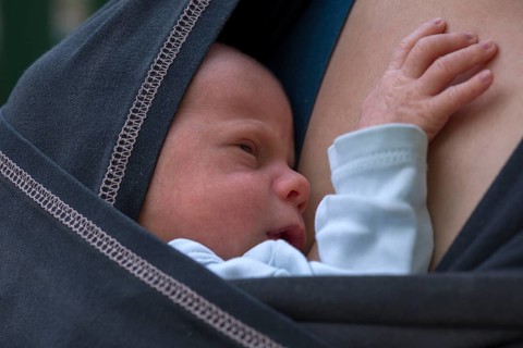 Infant in sling with mother