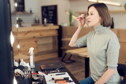 Woman applying eyebrow makeup