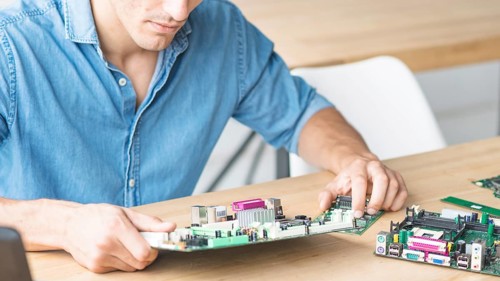 Close up hardware engineer repairing motherboard