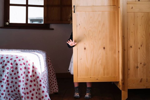 Girl standing wooden cupboard