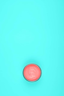 Overhead view coral paint turquoise green background
