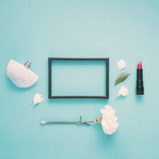 Blank frame with lipstick flower table