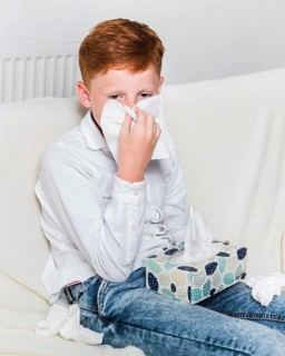Medium shot child blowing his nose