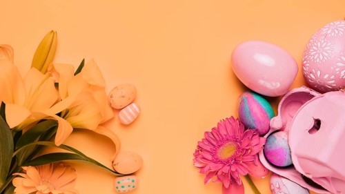 Fresh lily gerbera flowers with easter eggs yellow backdrop