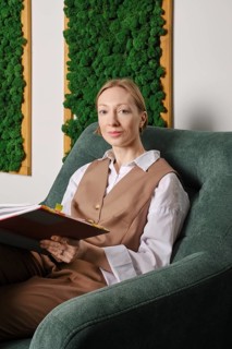 Cute woman sits relaxed in office recreation room