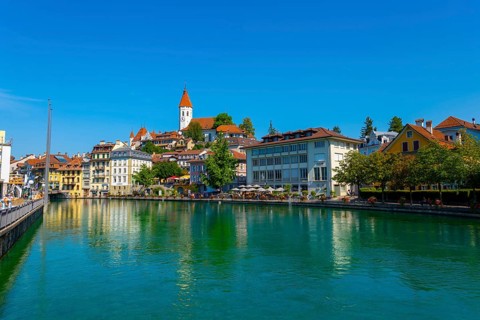City of Thun and River Aare with Castle and Church in a Sunny Day in Bernese Oberland