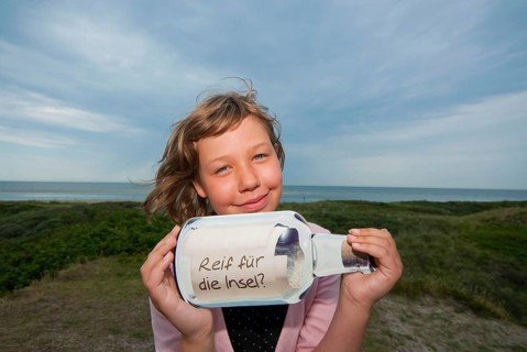 Child with message in a bottle
