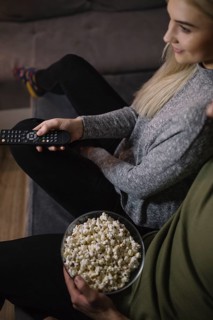 Crop couple watching tv sofa