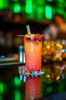 Vertical photo of a Sex on the beach cocktail on the counter of a luxury bar