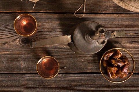 Dates fruit with tea glasses wooden table