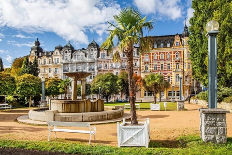 Row of houses with Art Nouveau facades by the autumnal spa park
