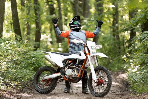 Front view man happy ride bike forrest