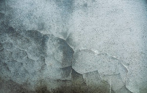 Textured old wall background. Texture of a gray wall. Old wall with cracked texture. Cracked cement wall background. Textured and cracked wall