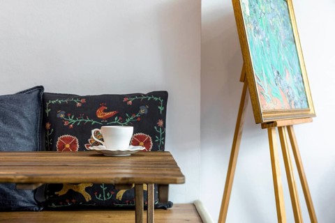 Coffee cup saucer wooden table front cushion easel