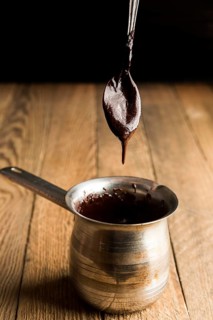 High angle teaspoon with melted chocolate pot