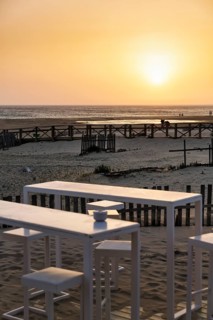 White tables and chairs in the sand