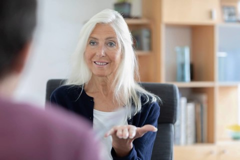 Therapist talking to a patient in a practice