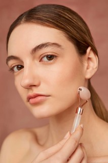 Close up woman posing with face tool