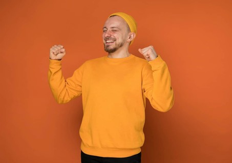 Happy young man laughing indoors 5