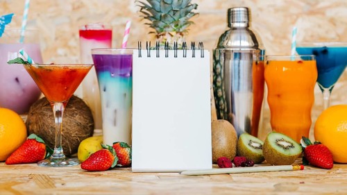 Cocktail tropical fruits with blank notepad