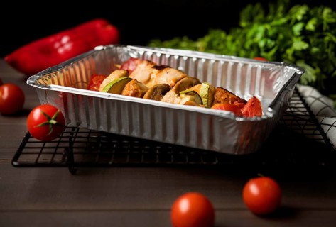 High angle chicken skewers tray with red pepper cherry tomatoes