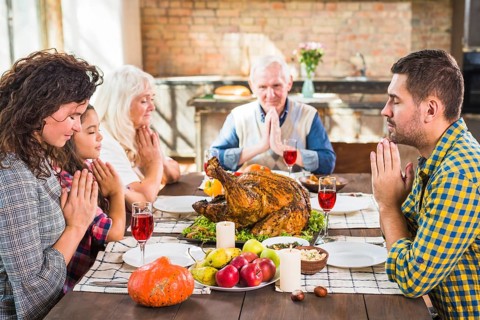 Family praying before meals