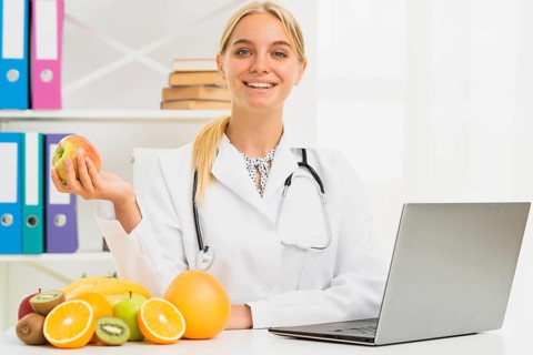 Medium shot smiley nutritionist with apple