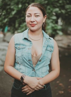 Portrait of attractive latin girl smiling outdoors. Portrait of Latin American girl face looking and smiling at the camera. Portrait of young Nicaraguan woman smiling at camera