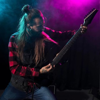 Artist playing guitar looking instrument