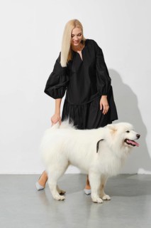 Happy blonde woman with fluffy samoyed dog