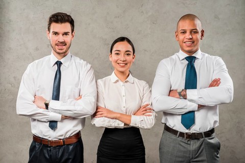 Confident young businessmen businesswoman with their arms crossed looking camera