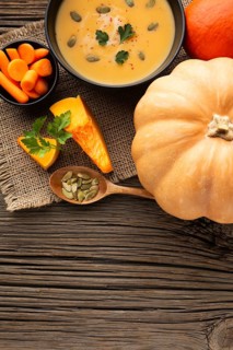 Flat lay pumpkin soup carrots pumpkin with copy space