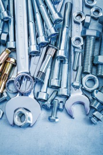 Anchor bolt bolt nuts hook spanner and flat spanner on metallic background repair concept