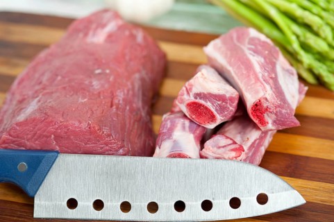 Raw beef and pork ribs with asparagus and herbs ready to cook