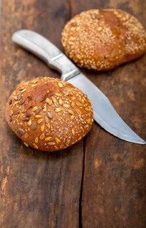Fresh organic bread over rustic table macro closeup
