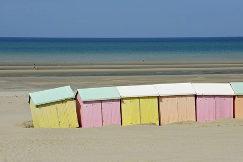 Row of colourful beach cabins in pastel colours along the North Sea at Berck