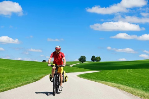 Cyclist on a picture-book country road near Berg