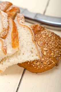 Fresh organic bread over rustic table macro closeup
