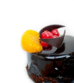 Chocolate cake and fresh fruit on top closeup macro