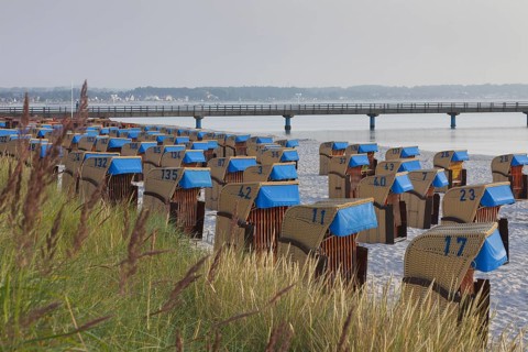 Roofed wicker beach chairs along the Baltic Sea at Scharbeutz