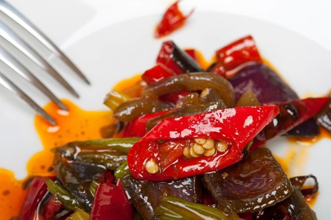 Fried chili pepper and vegetable on a iron wok pan