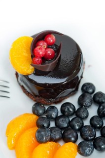 Chocolate cake and fresh fruit on top closeup macro