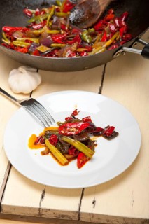 Fried chili pepper and vegetable on a iron wok pan