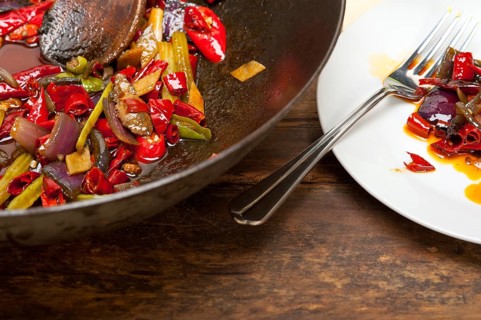 Fried chili pepper and vegetable on a iron wok pan